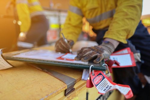 Lock out tags and lock out locks on a clipboard in a construction zone