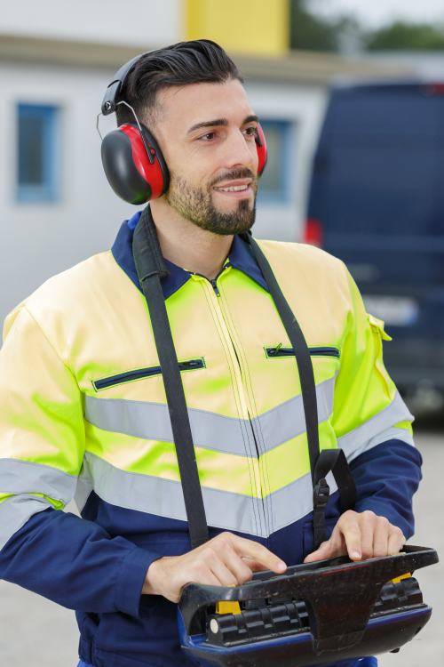 worker using remote control for crane